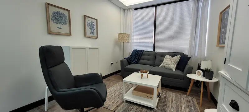 Natural light filling a corner therapy office available for rent.