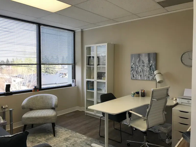 A view of the therapists desk and chair in a professionally furnished rental office.